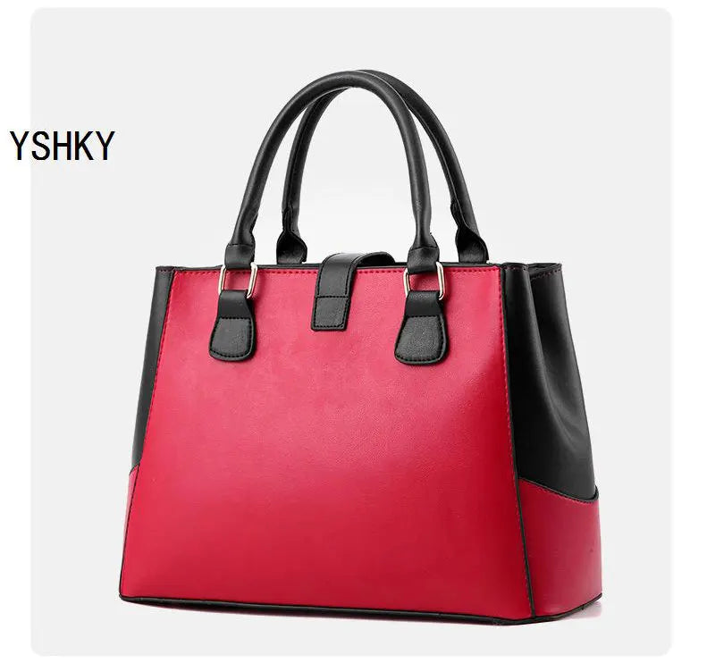 Red handbag with black accents on a white background, featuring the brand 'YSHKY'.