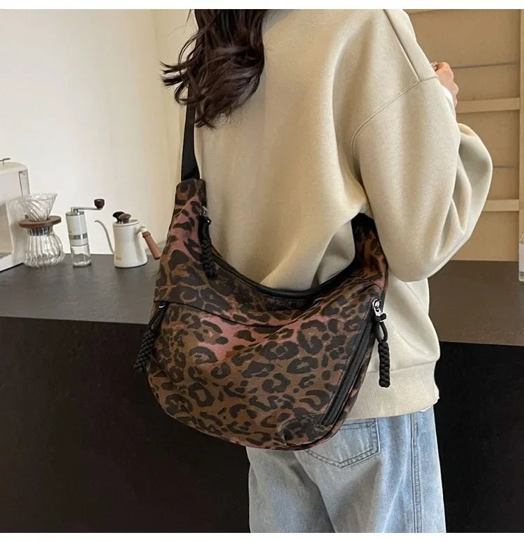 Person wearing a leopard print bag in a casual setting