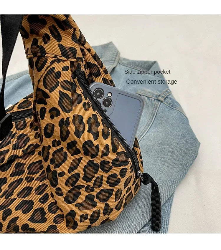Leopard print bag with a side zipper pocket on a light background