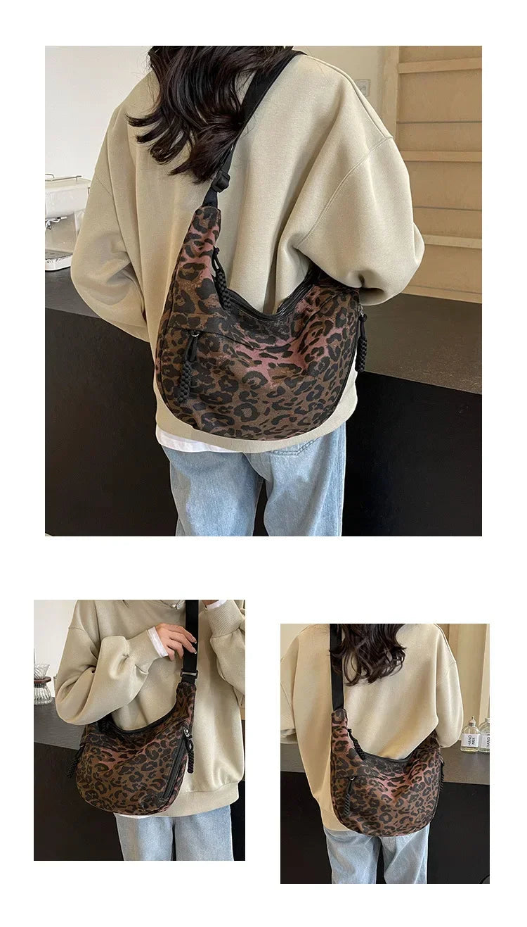 Person wearing a beige sweater and blue jeans with a leopard print bag.