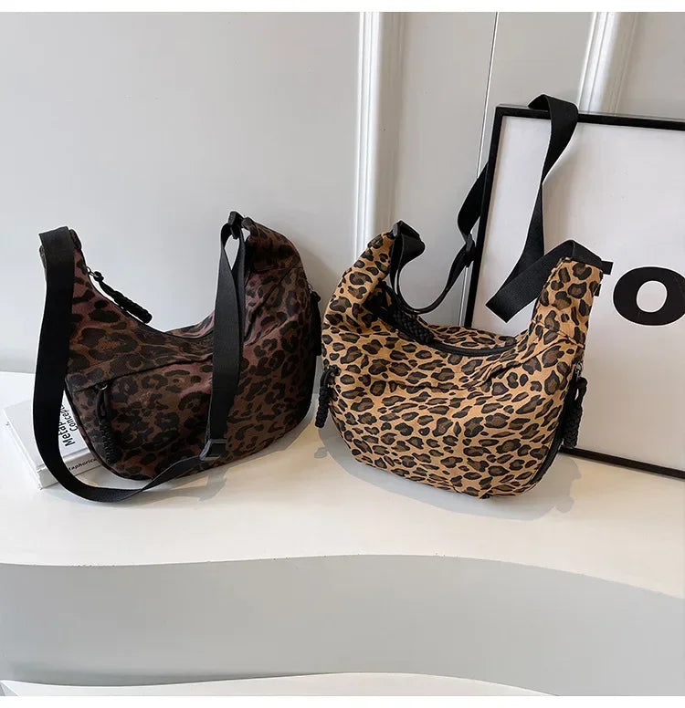 Two leopard print bags on a white surface with a black and white frame in the background.