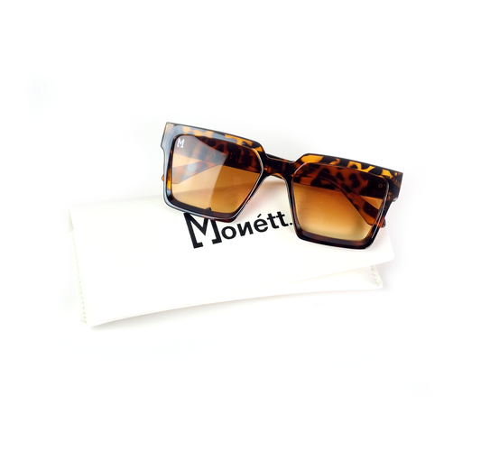 Sunglasses with tortoiseshell frame and brown lenses on a white background with 'Monett' branding.