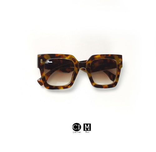 Tortoiseshell sunglasses on a white background with a visible brand logo.