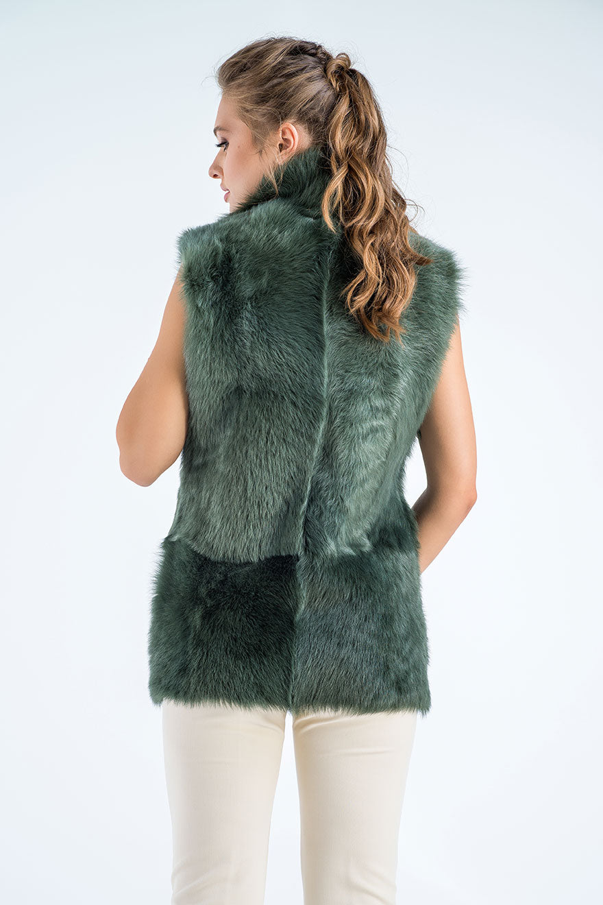 Woman wearing a green fur vest on a white background