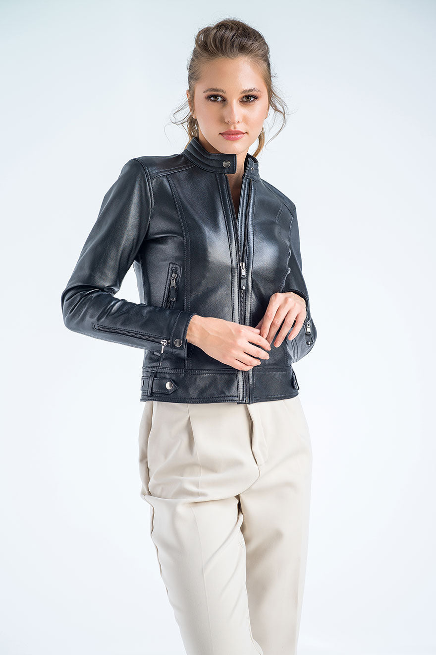 Woman wearing a black leather jacket on a white background