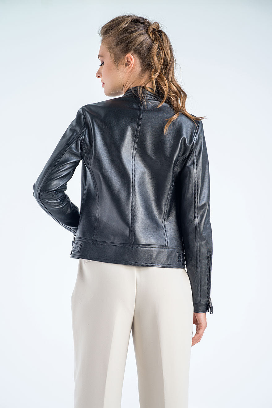 Woman wearing a black leather jacket on a white background