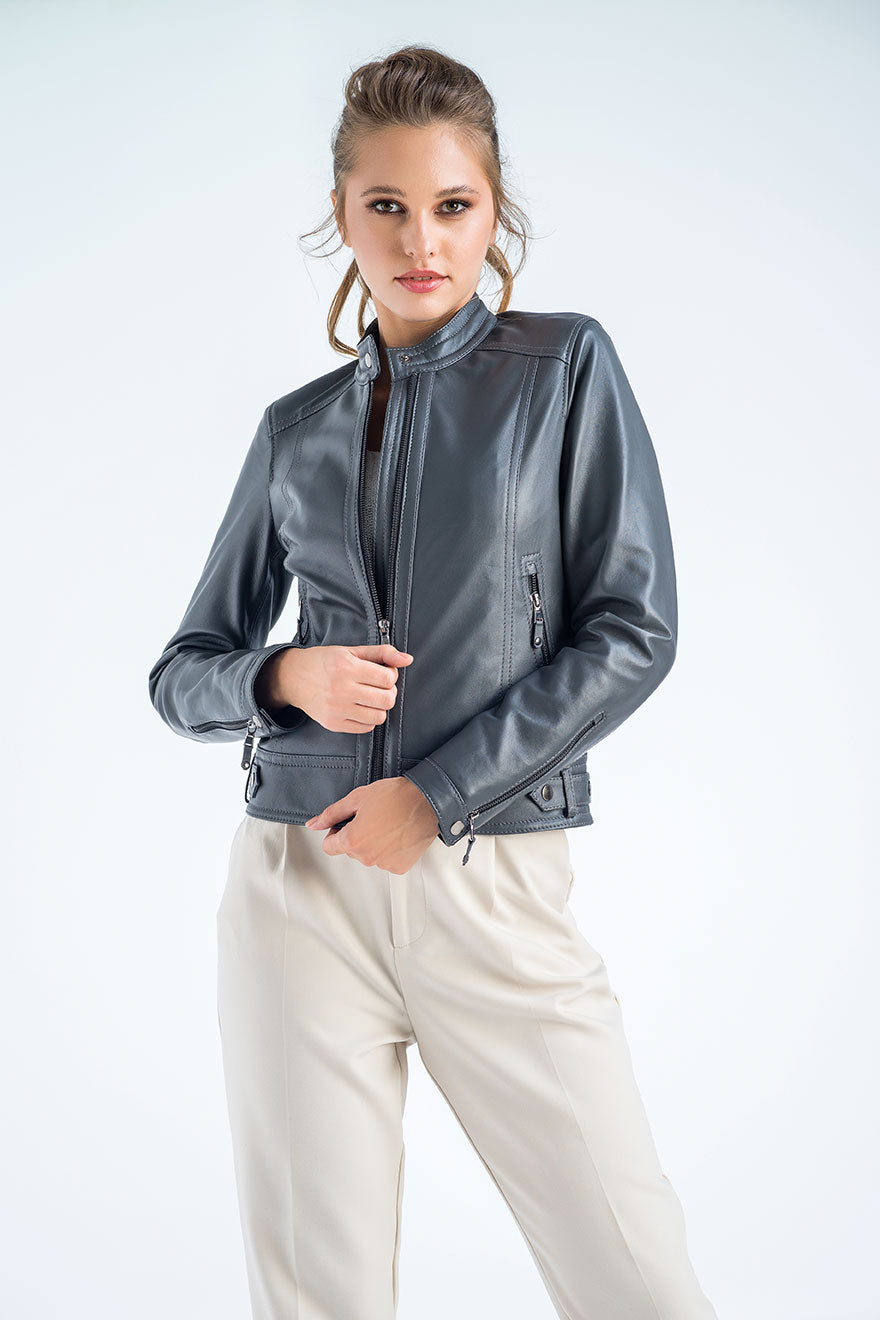 Woman wearing a gray leather jacket on a white background
