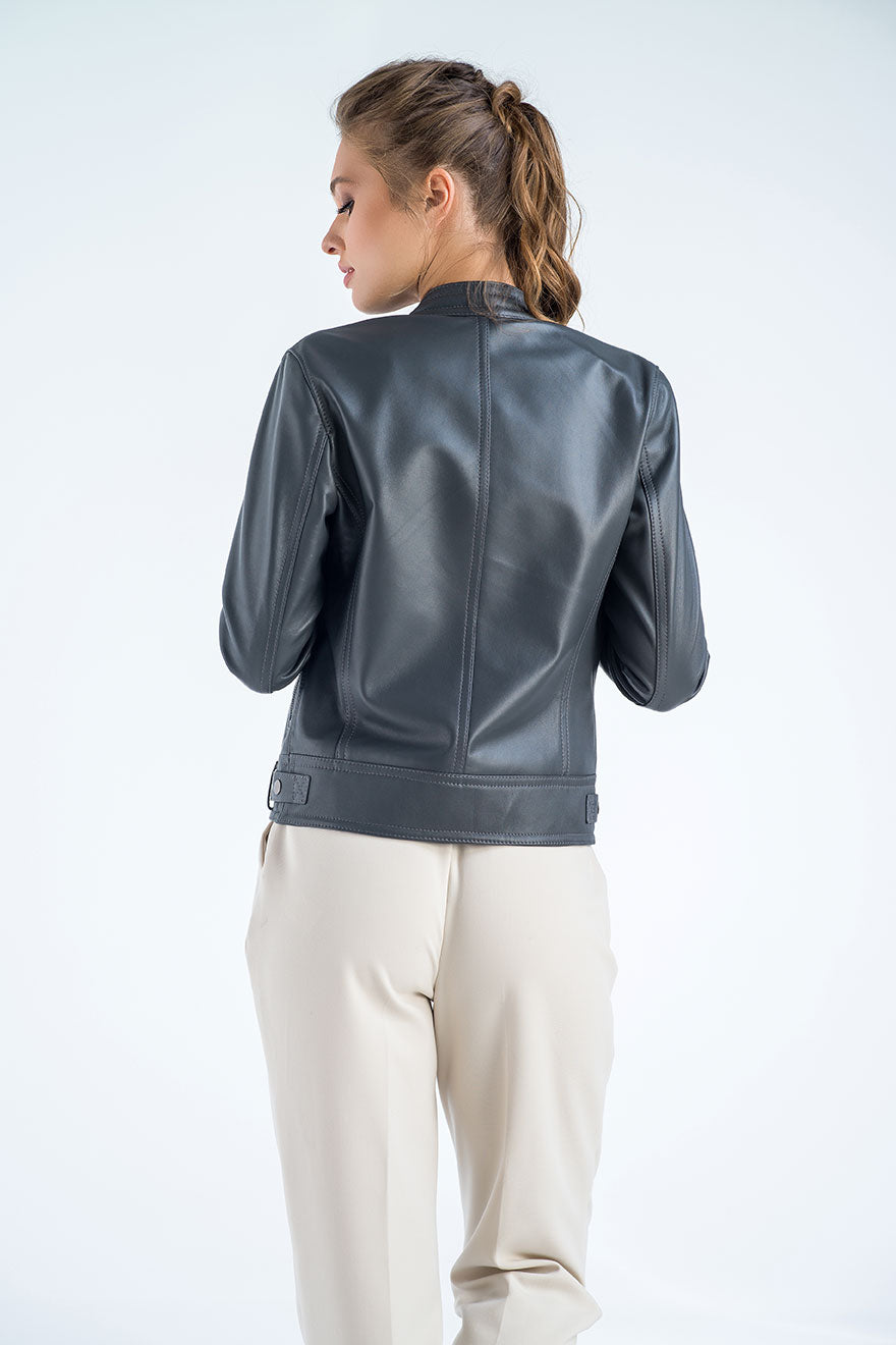 Person wearing a gray leather jacket on a white background