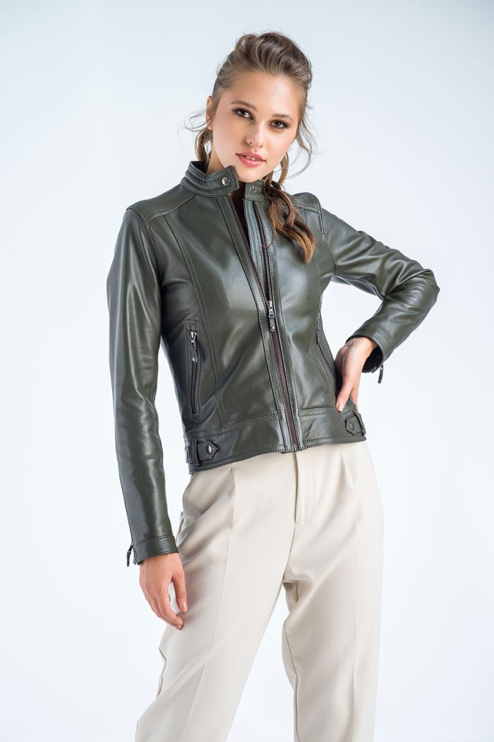 Woman wearing a green leather jacket on a white background