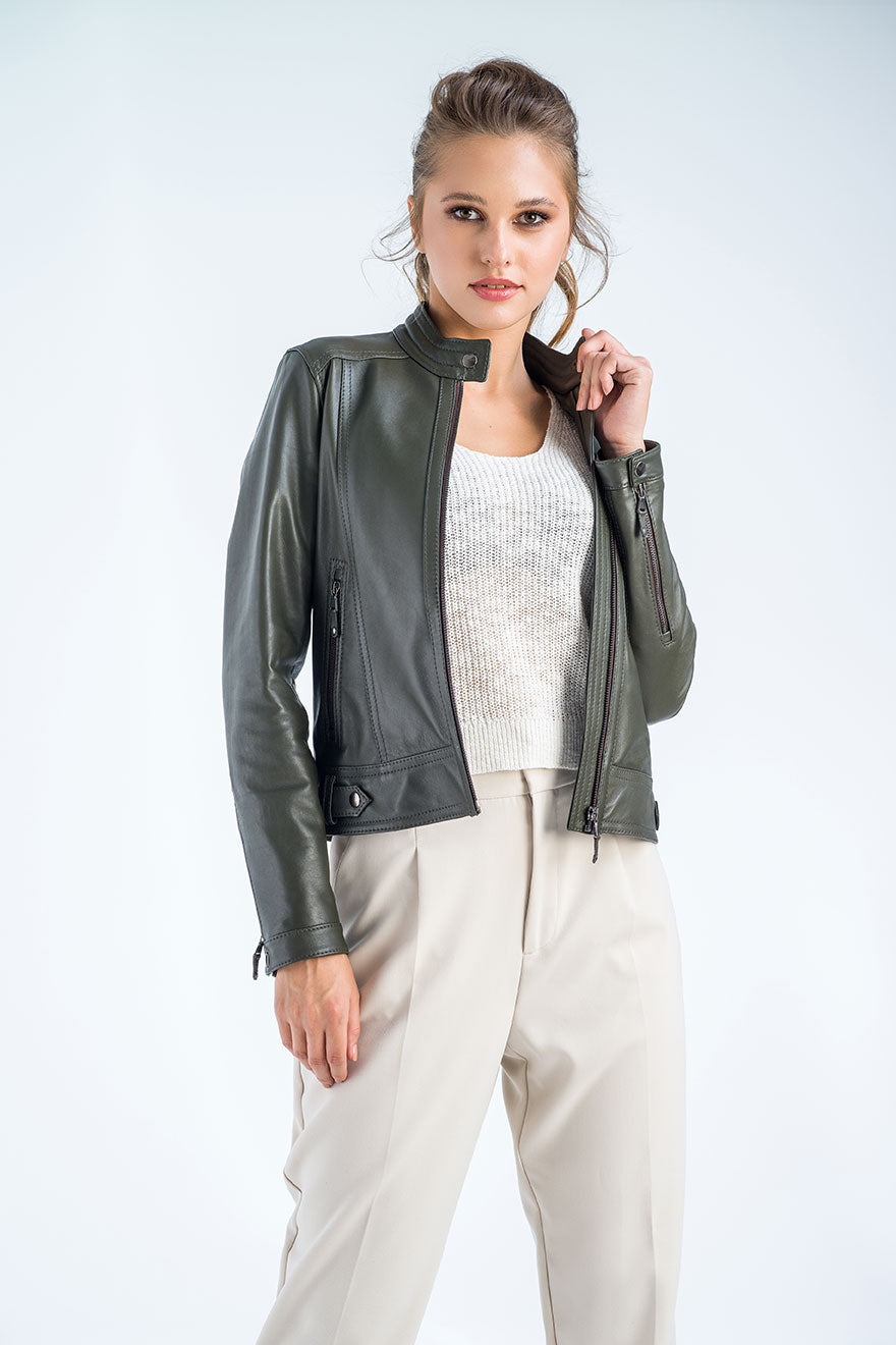 Woman wearing a green leather jacket on a white background