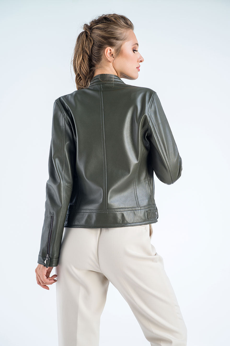 Woman wearing a green leather jacket on a white background