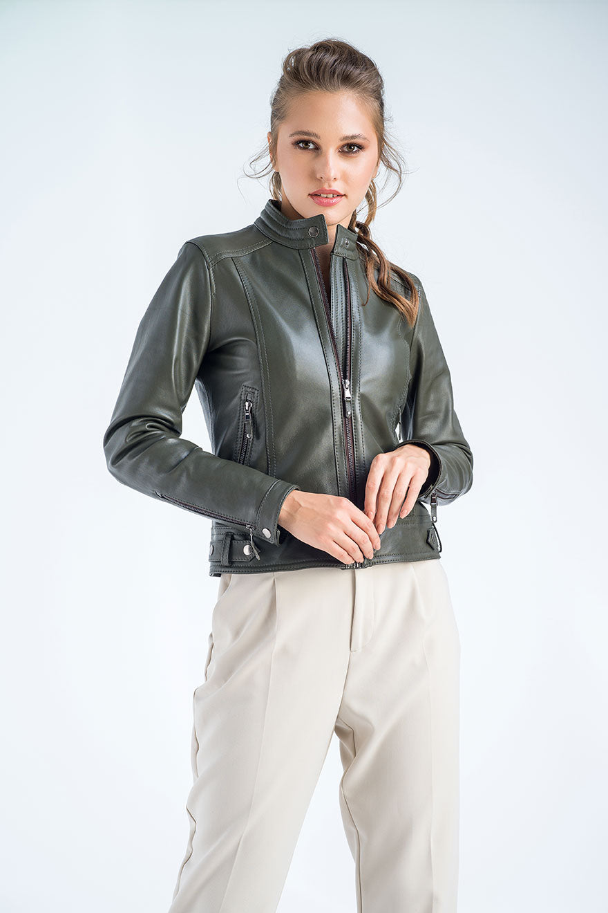 Woman wearing a green leather jacket on a white background