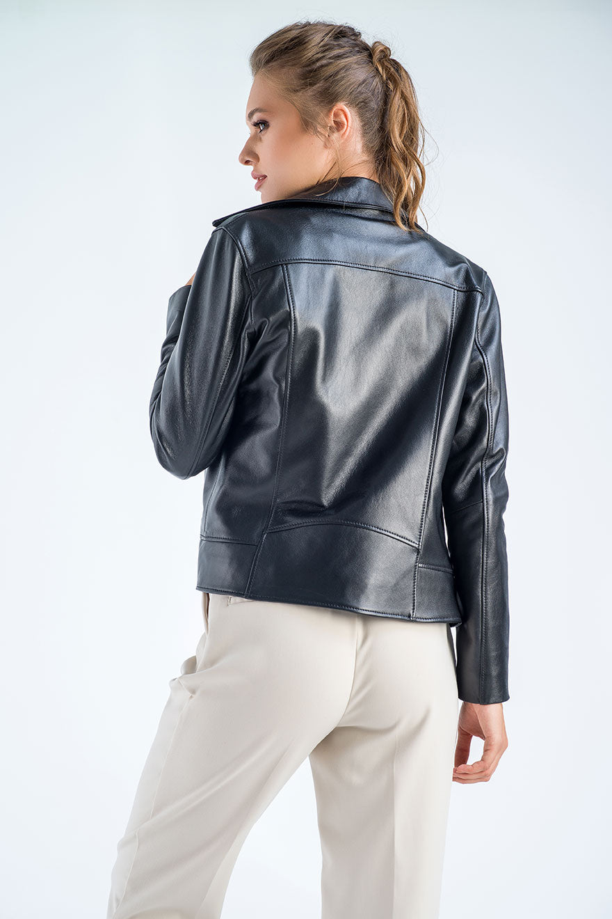 Woman wearing a black leather jacket on a white background
