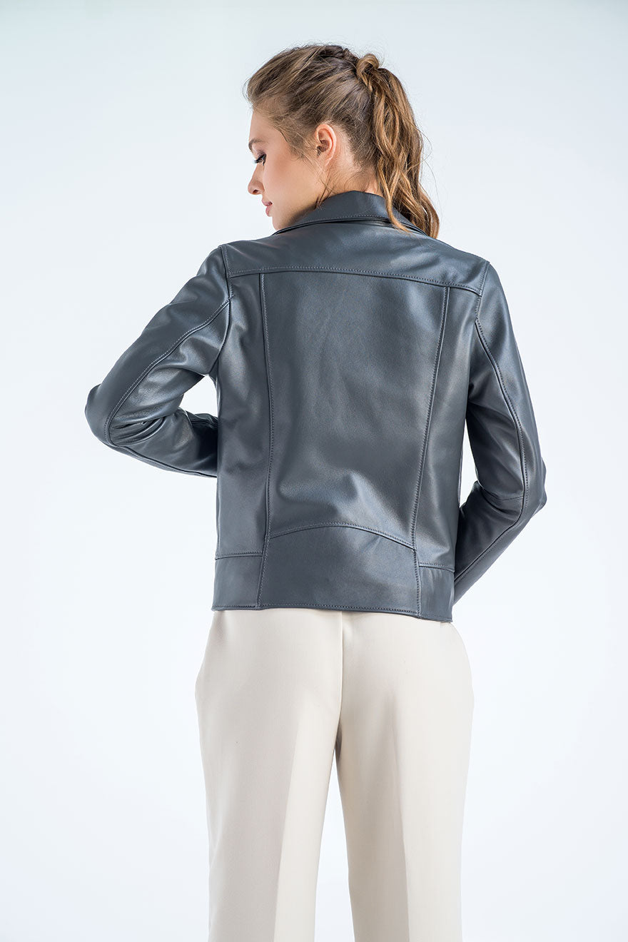 Woman wearing a gray leather jacket on a white background