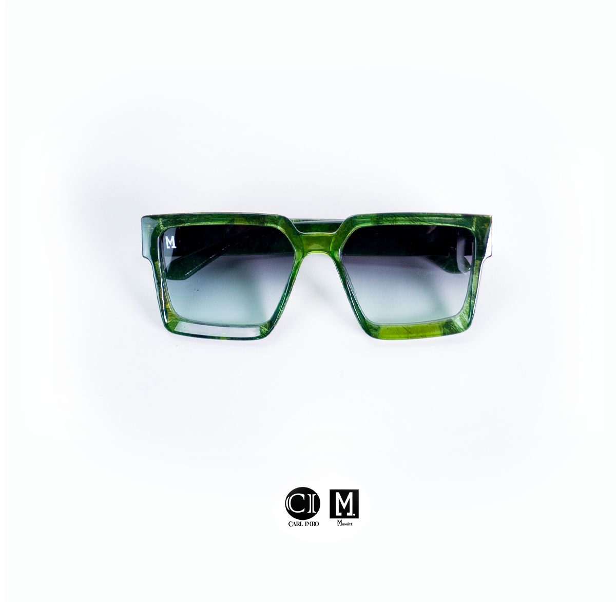 Green sunglasses with a gradient lens on a white background, featuring the brand 'CIM'.