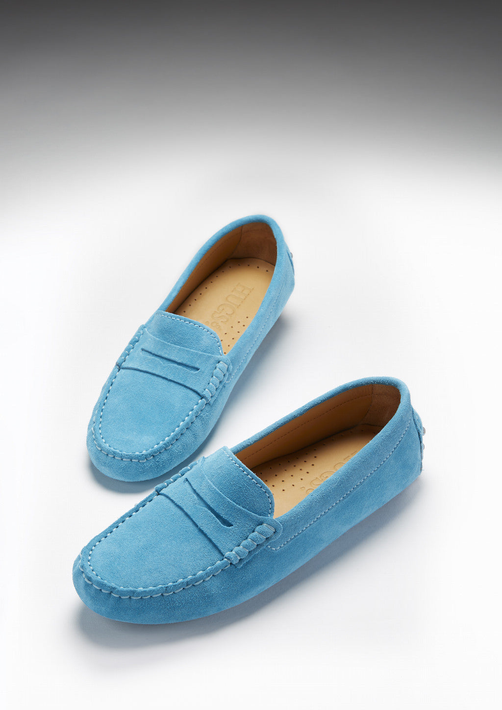 Pair of blue loafers on a white background