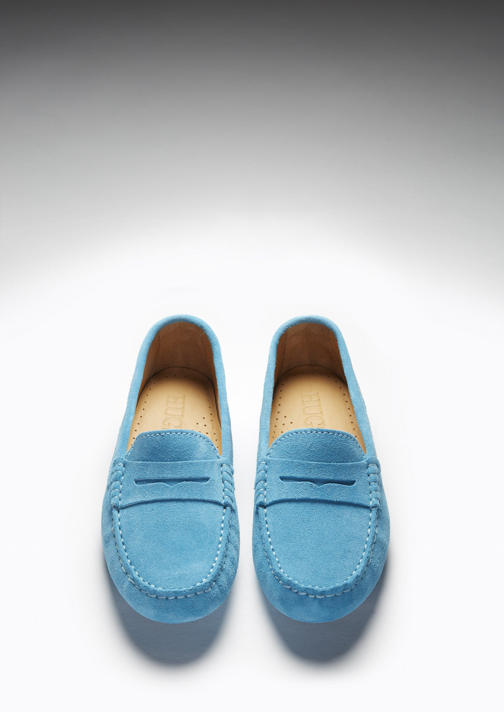 Pair of blue loafers on a light gray background