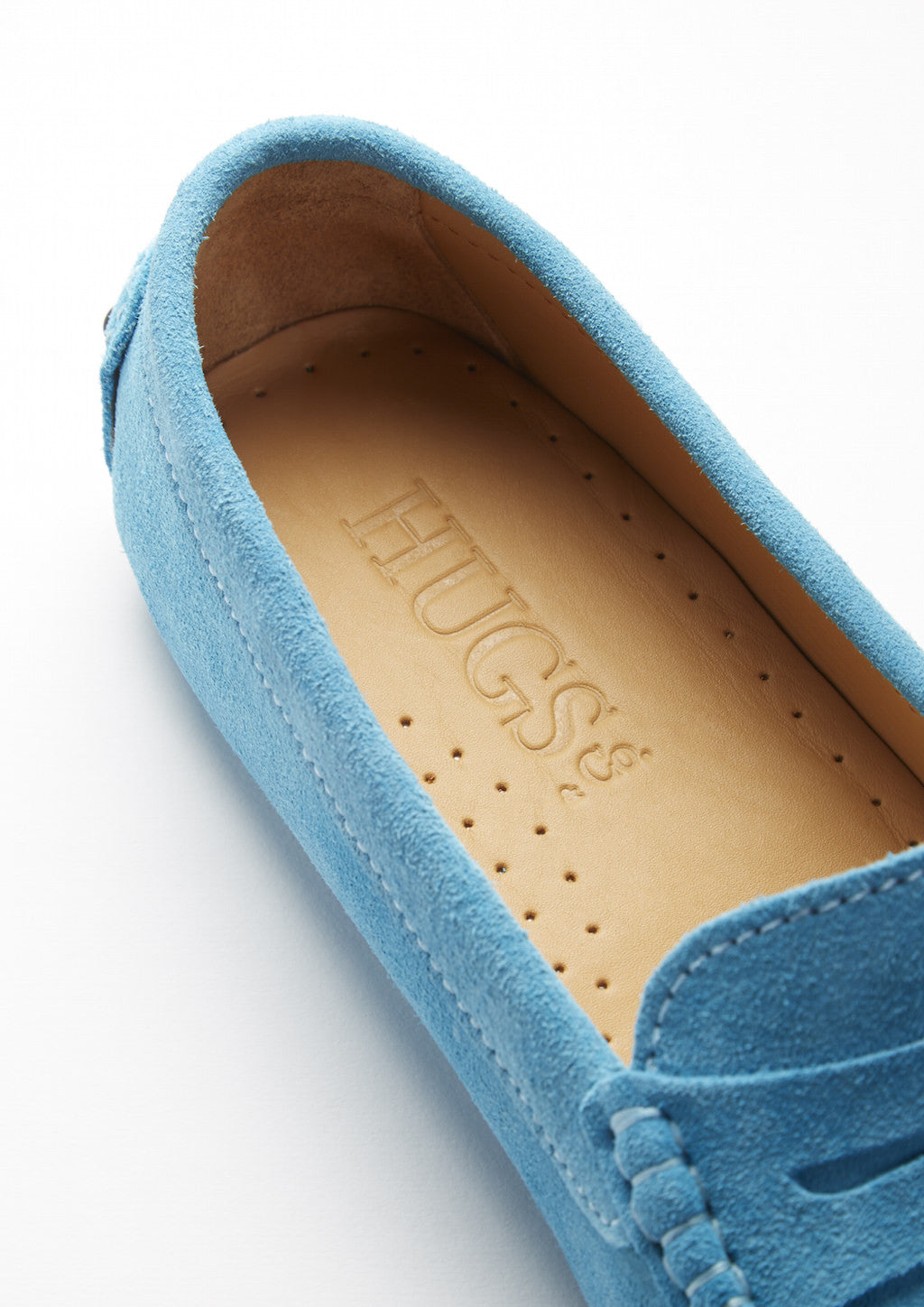 Blue suede loafer with 'Hugs' branding on a white background