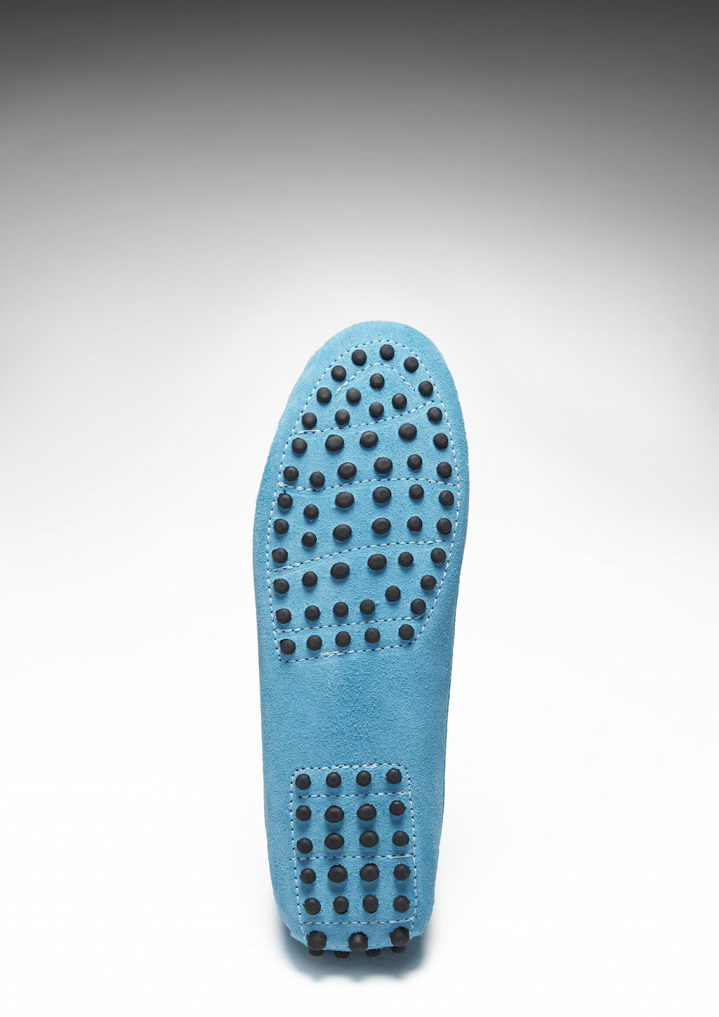 Blue shoe sole with textured sole pad on a white background