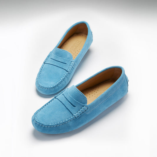 Pair of blue loafers on a light gray background