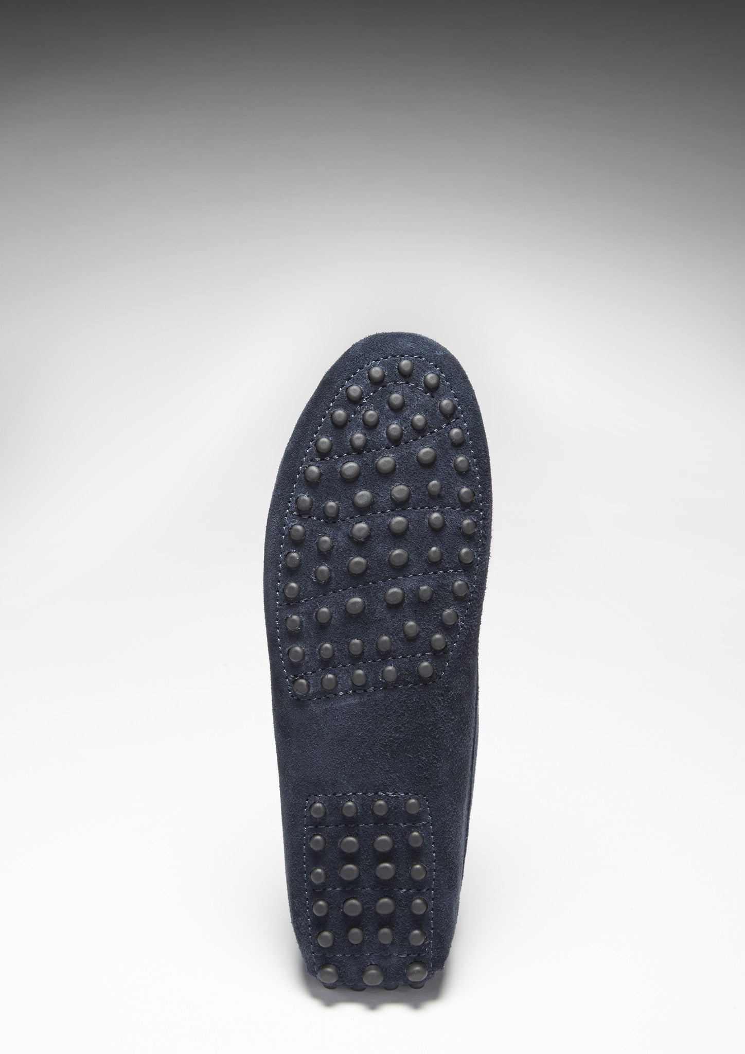 Black shoe sole with textured pattern on a white background