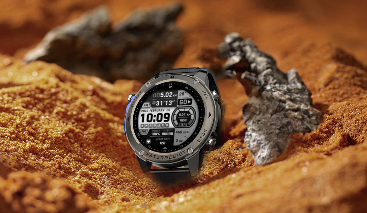 Smartwatch on a sandy surface with rocks