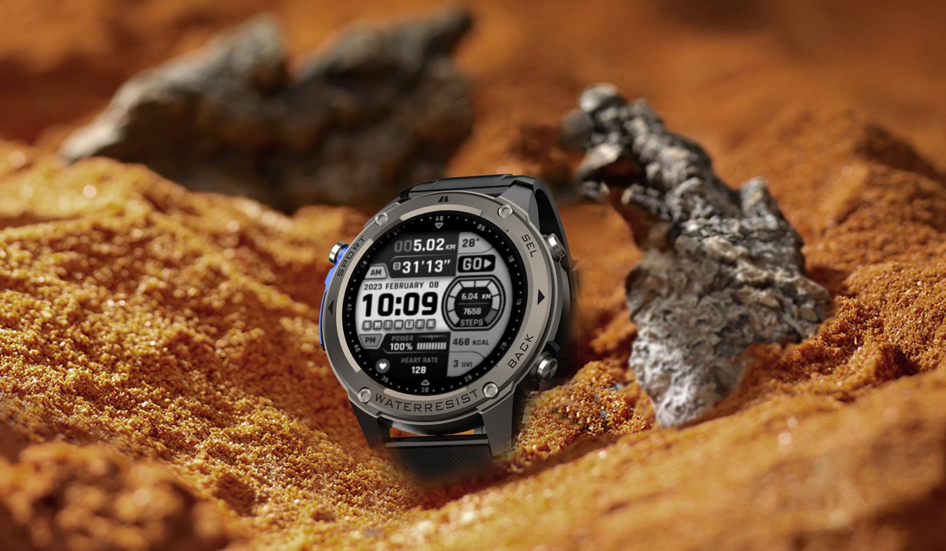Smartwatch on a sandy surface with rocks