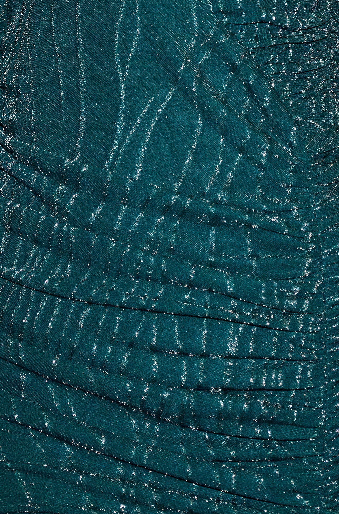 Close-up of teal fabric with a textured pattern