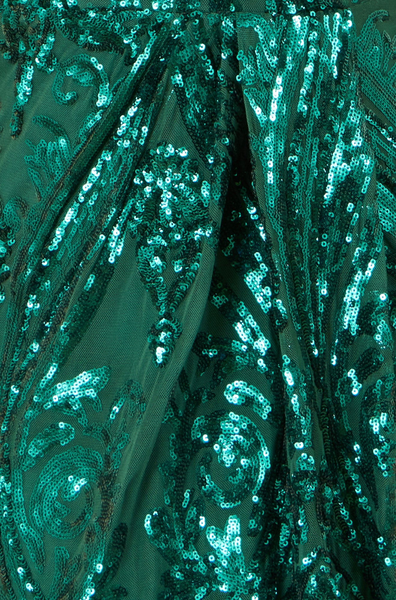 Close-up of a green sequined fabric with intricate patterns