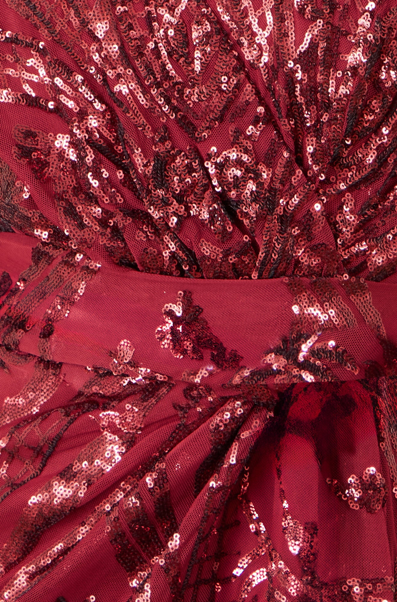 Close-up of red sequin fabric with intricate patterns
