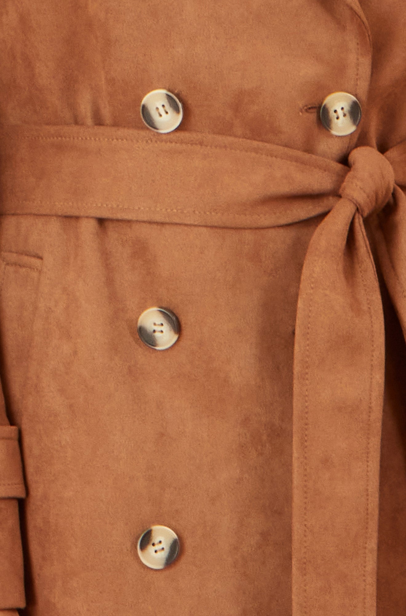 Close-up of a brown coat with buttons and a tie waist.
