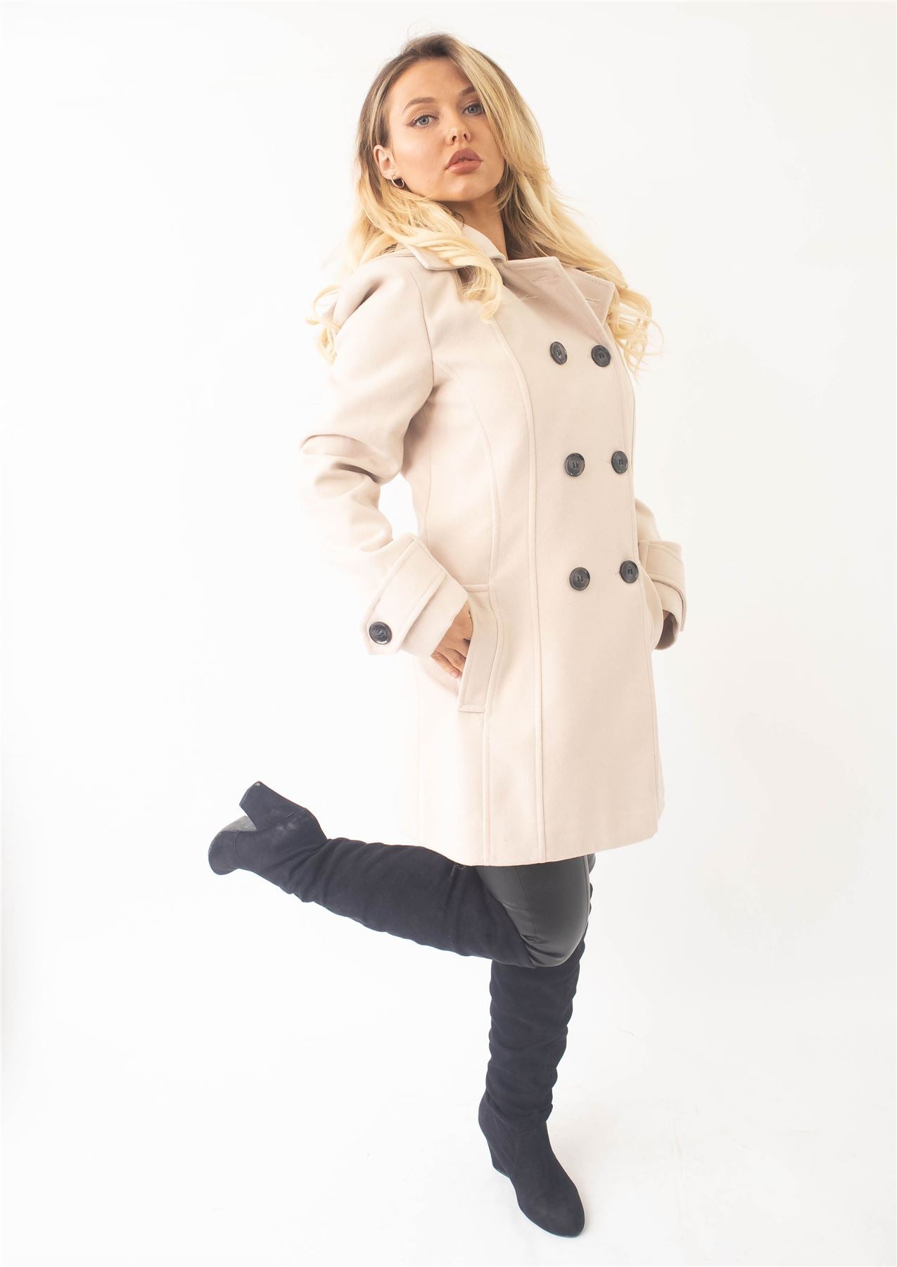 Woman wearing a beige coat on a white background