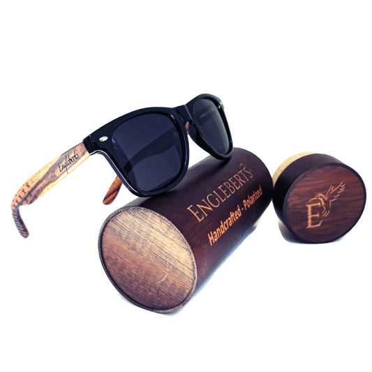 Sunglasses with wooden case and 'Engleberts' branding on a white background
