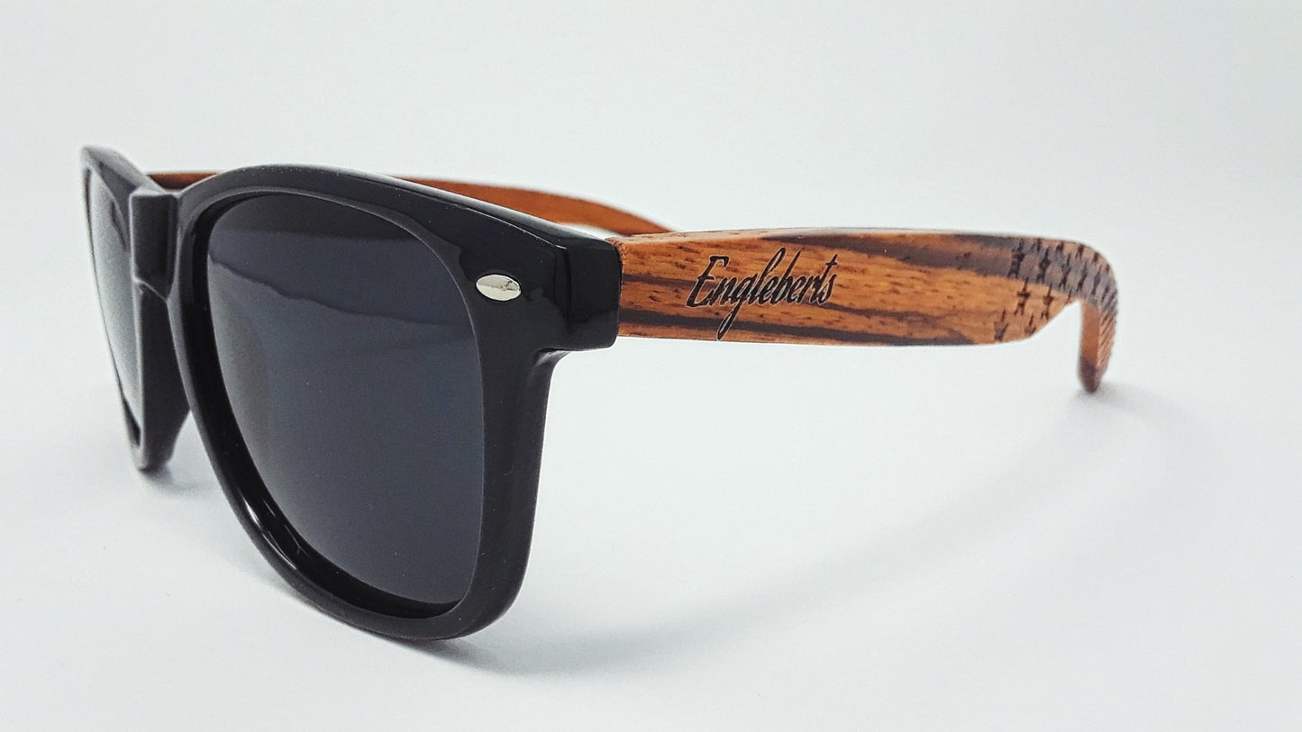 Sunglasses with wooden frame and black lenses on a white background