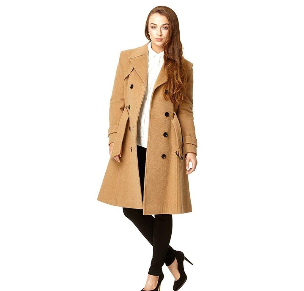 Woman wearing a beige trench coat on a white background