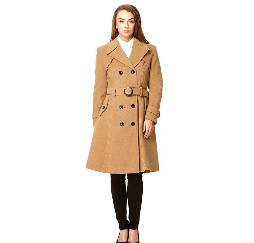 Woman wearing a tan trench coat on a white background