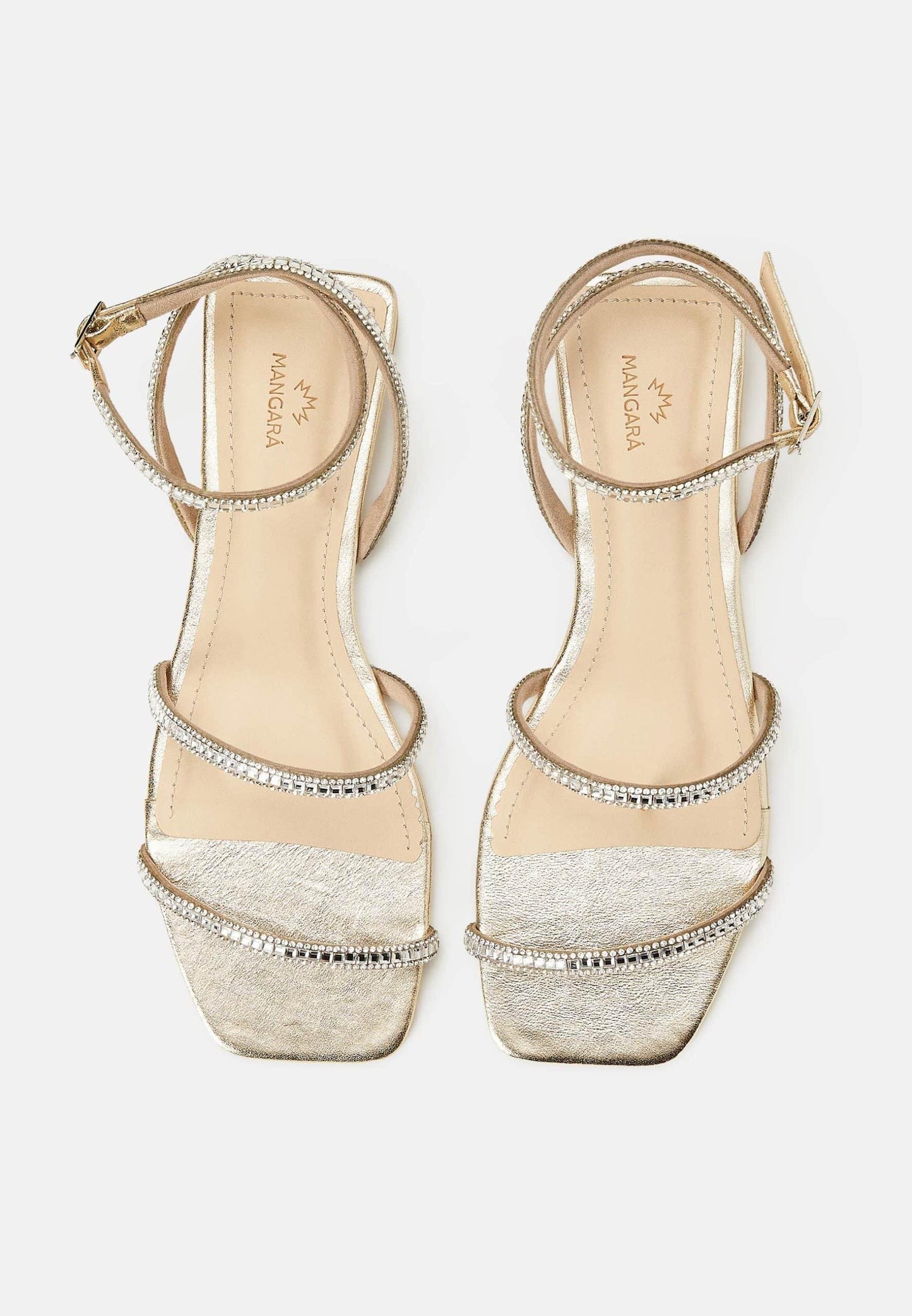 Pair of embellished sandals on a white background