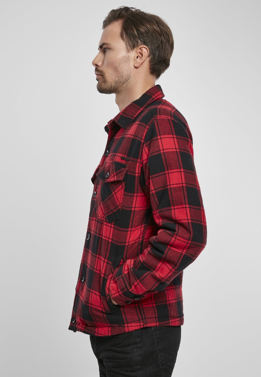 Man wearing a red and black plaid shirt on a white background