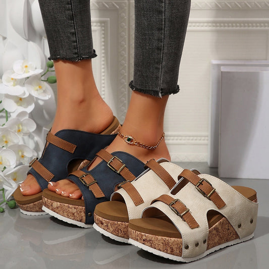 Two pairs of sandals, one black and one beige, worn on feet with a neutral background.