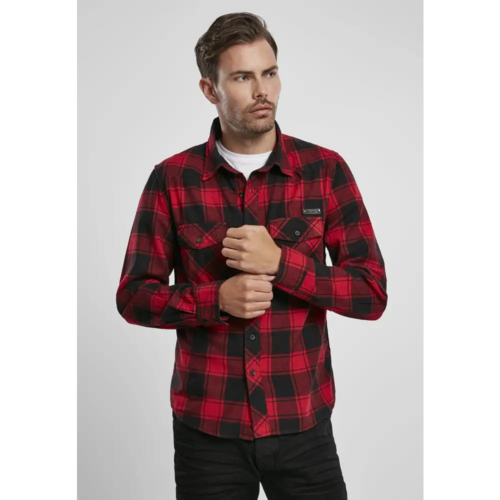 Man wearing a red and black plaid shirt on a light gray background