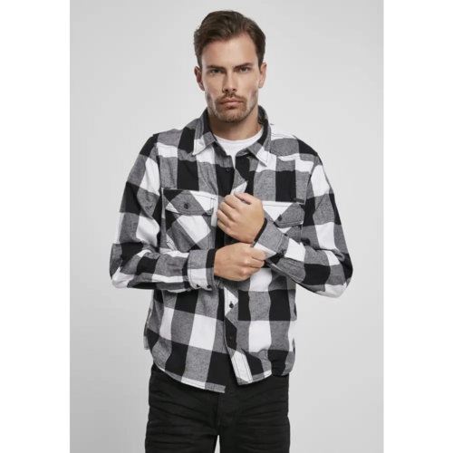 Man wearing a black and white checkered shirt against a plain background