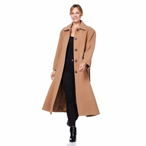 Woman wearing a long beige coat on a white background