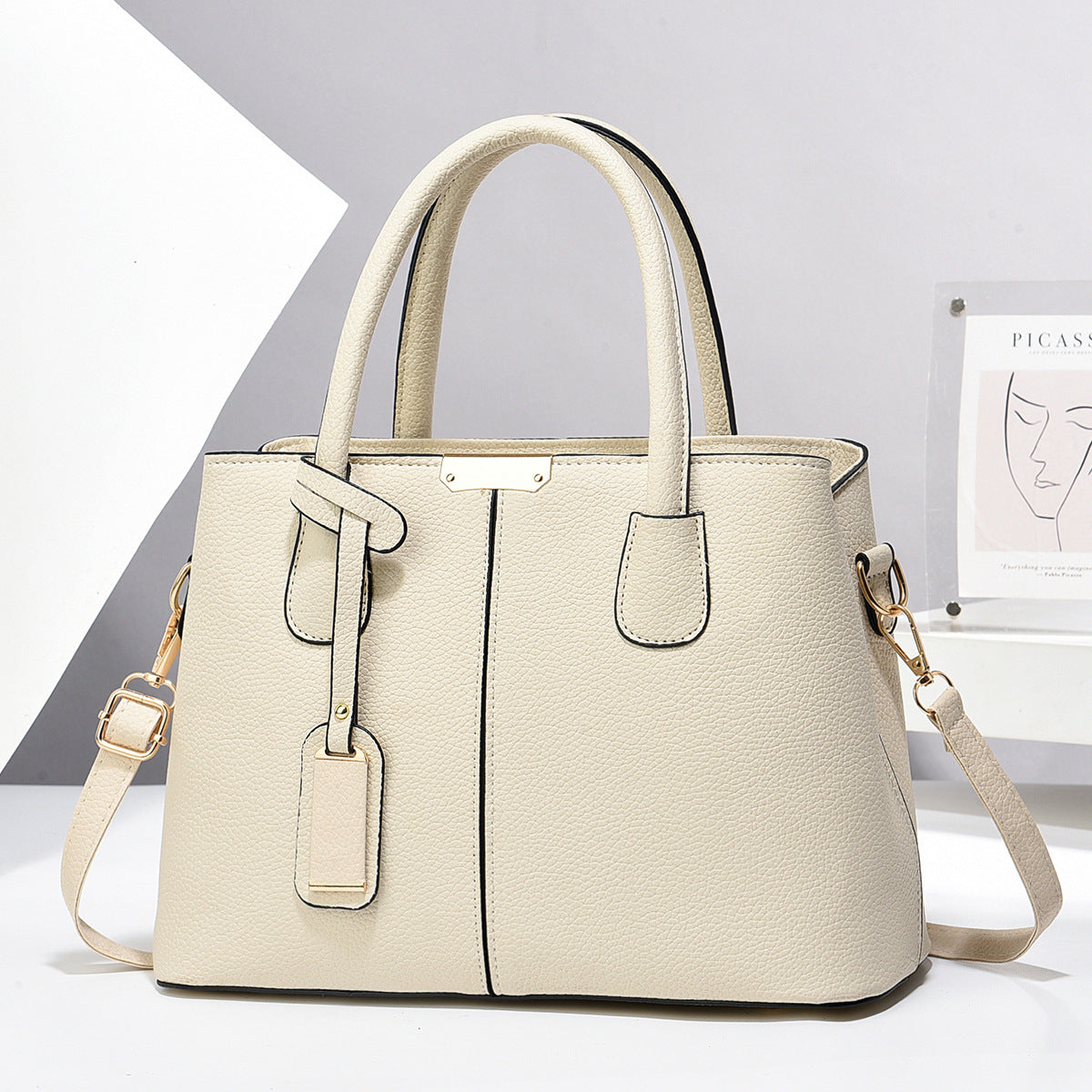 Beige handbag with a strap on a white background