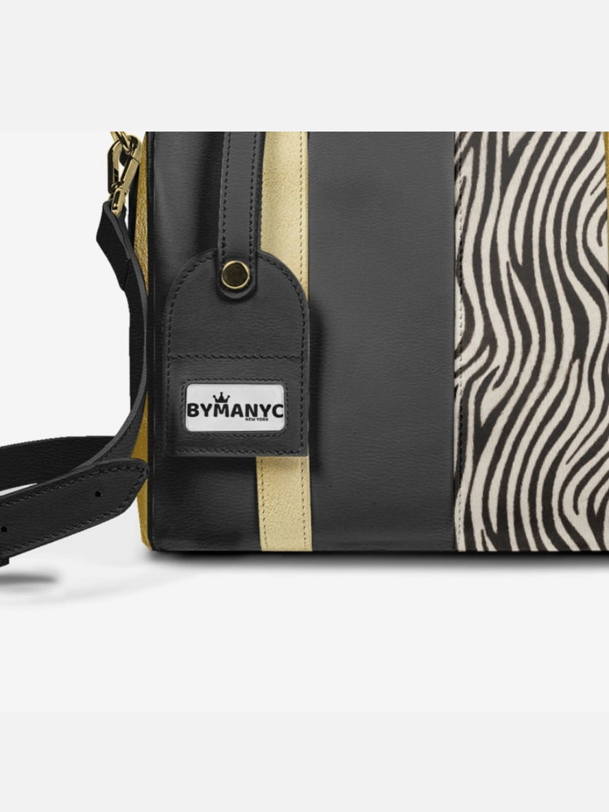 Black handbag with zebra pattern and BYMANYC logo on a white background