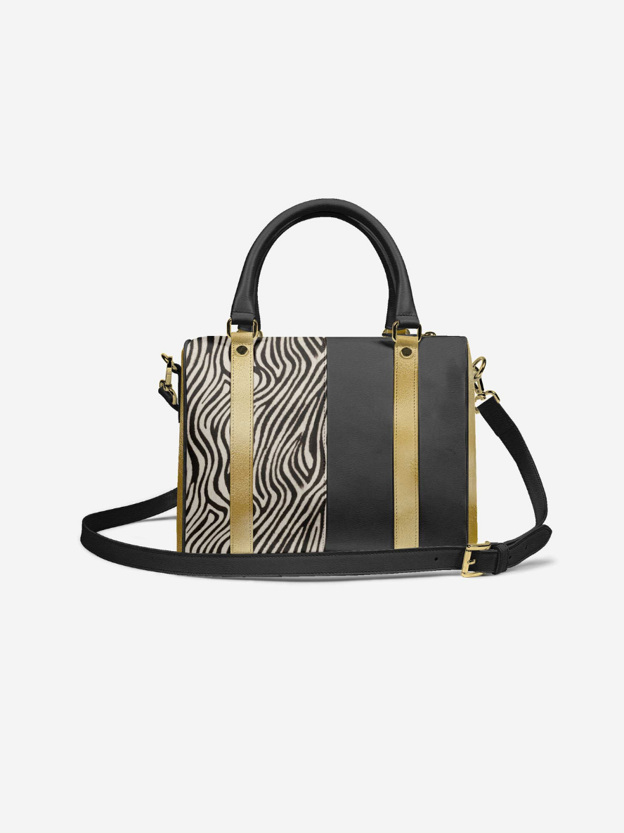 Handbag with zebra print and gold accents on a white background