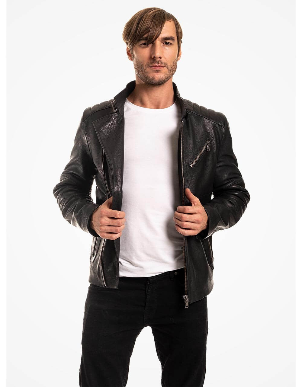 Man wearing a black leather jacket over a white shirt on a white background