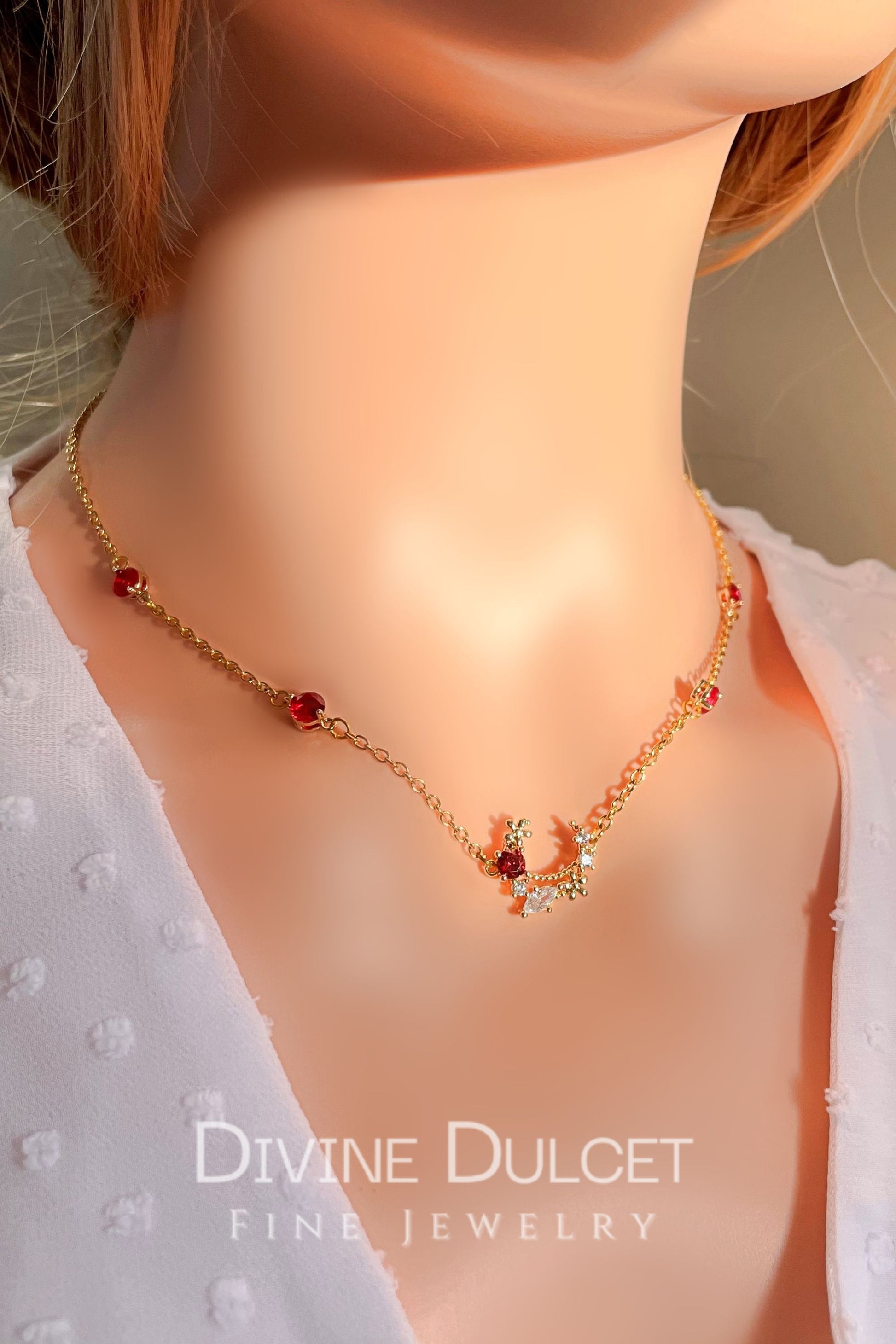 Necklace with red beads and gold accents on a mannequin with 'Divine Dulcet' branding.