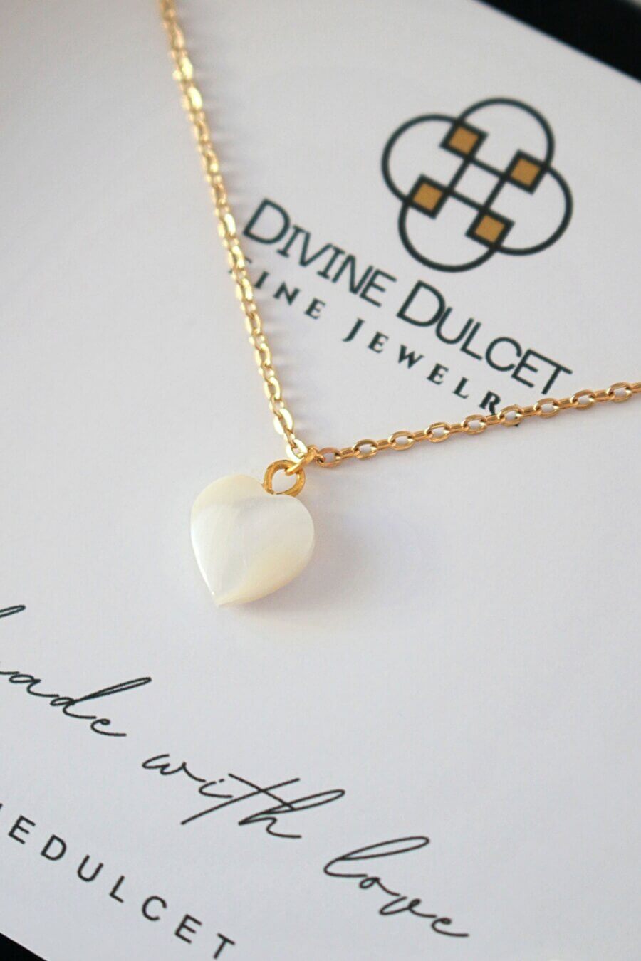 Necklace with a heart-shaped pendant on a Divine Dulcet jewelry card.