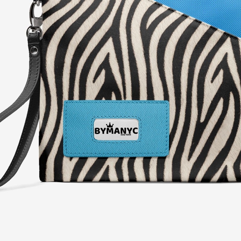 Zebra patterned clutch with a blue tag featuring 'BY MANYC' on a white background