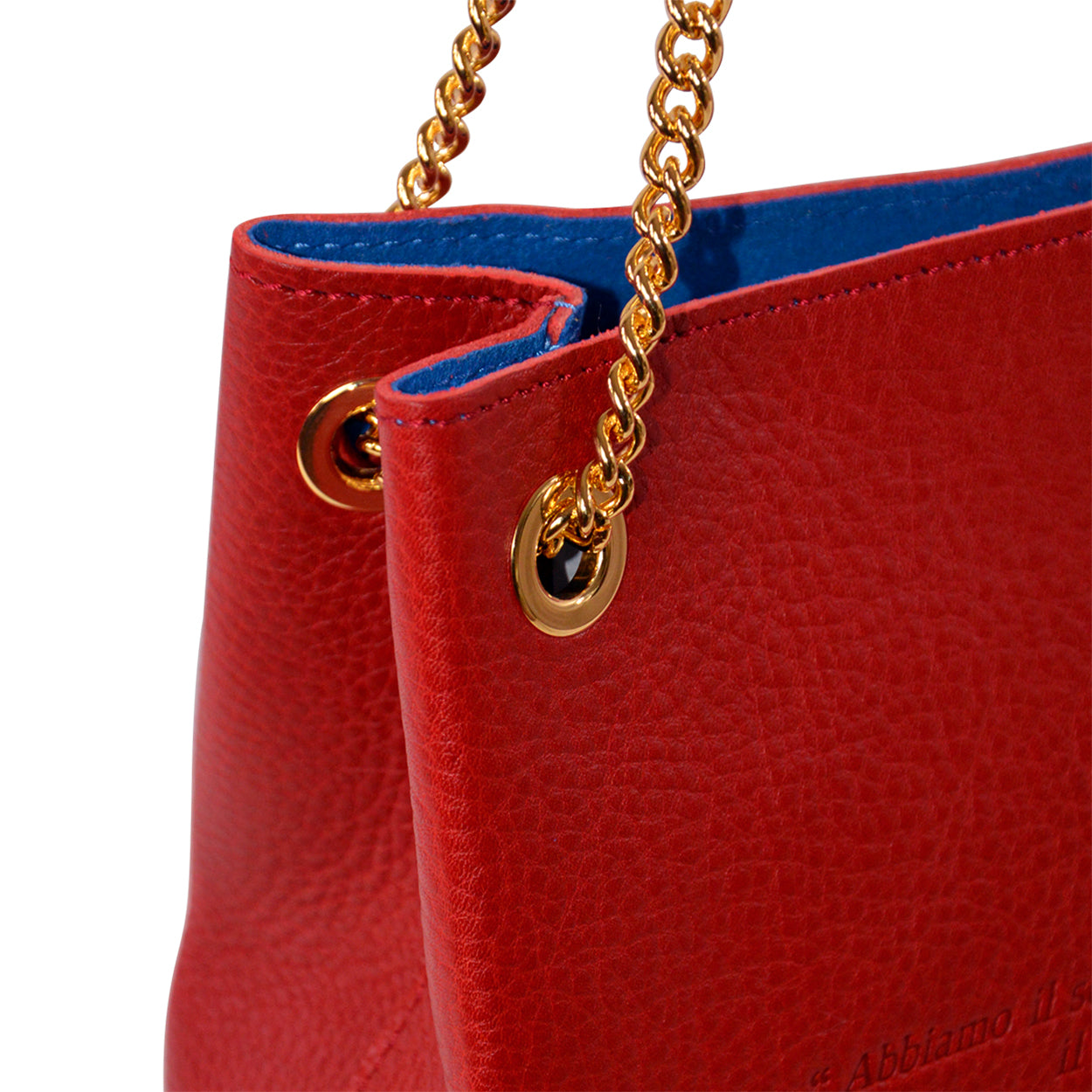 Red handbag with gold chain handle on a white background